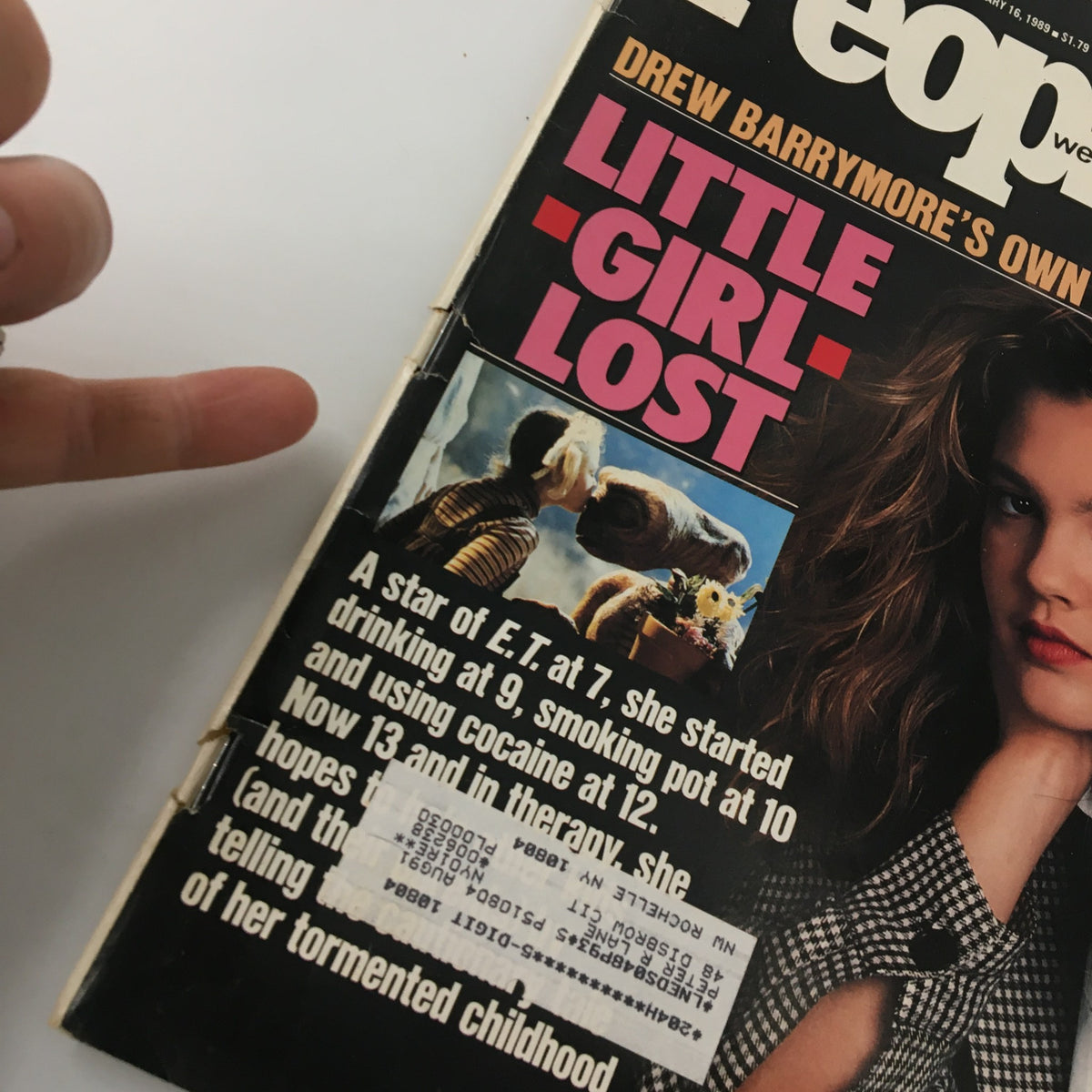 Close-up of the January 1989 People Weekly magazine cover featuring Drew Barrymore and the title 'Little Girl Lost'. The cover presents her in a candid pose, reflecting on her tumultuous childhood.