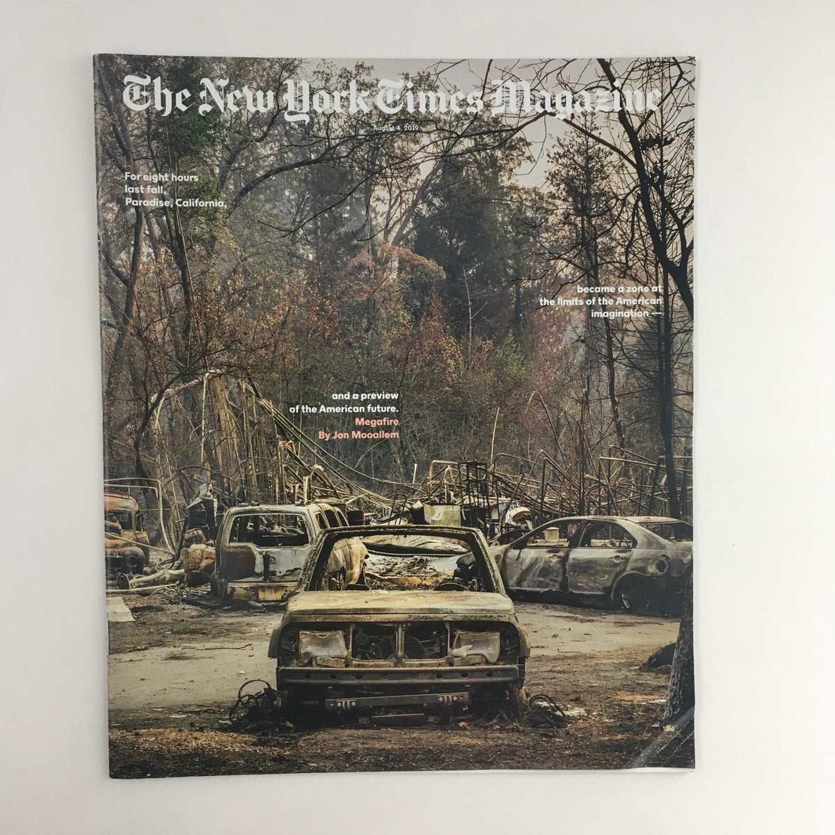 Cover of The New York Times Magazine August 4, 2019, depicting the aftermath of the megafires in Paradise, California, featuring burnt vehicles amidst a charred landscape.