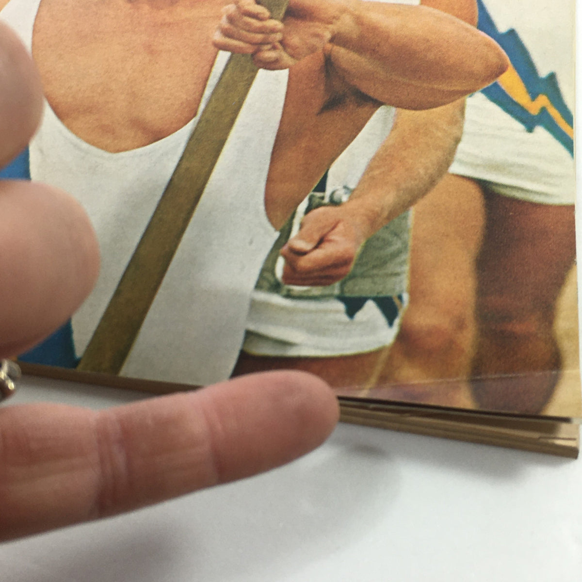 Close-up of a hand holding a paddle, showcasing strong arm muscles, from the VTG Newsweek Magazine February 21 1966 - Australia On The March edition.