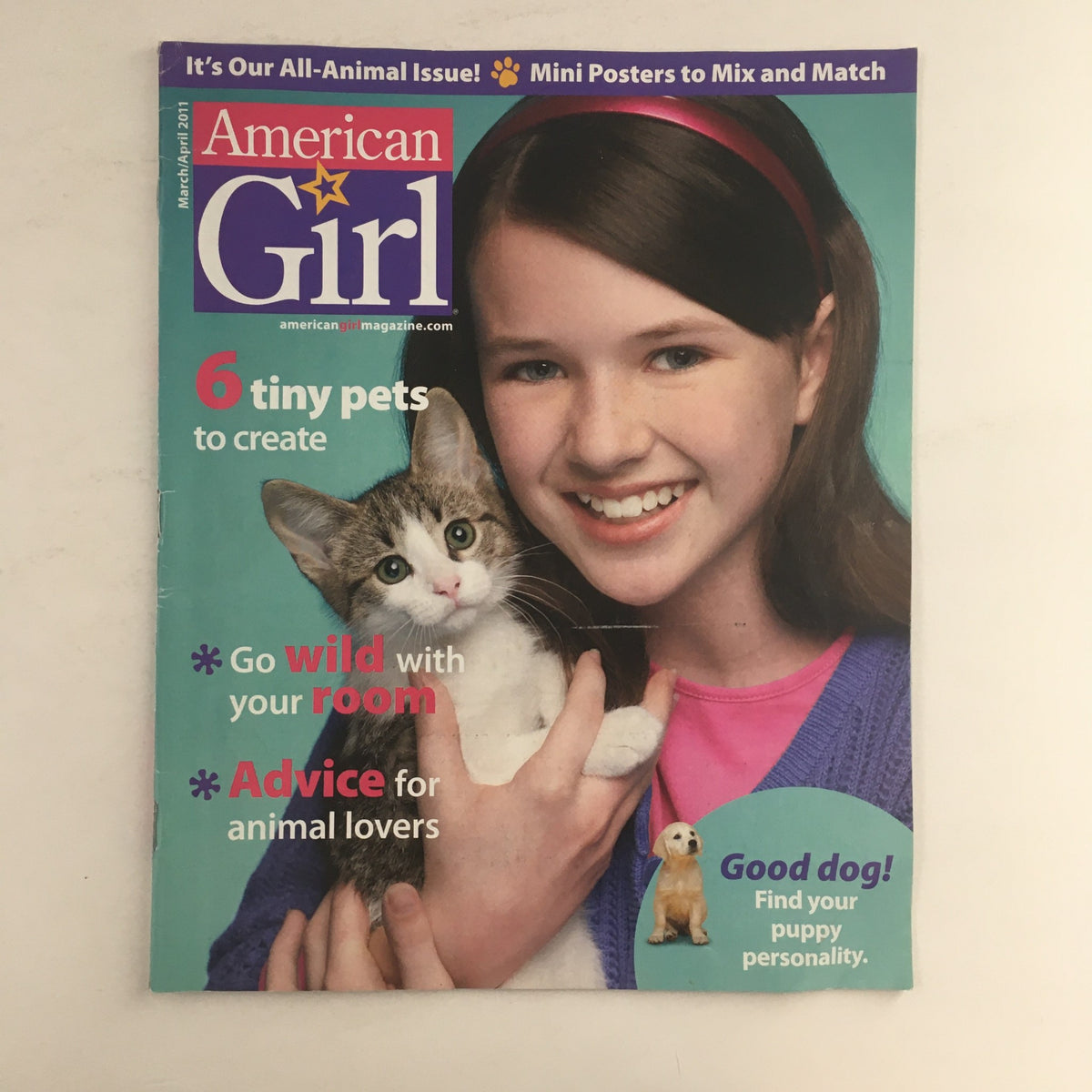 Cover of American Girl Magazine March 2011 featuring a girl holding a kitten with the title '6 tiny pets to create & advice for animal lovers'. It includes visuals depicting the theme of animal companionship.