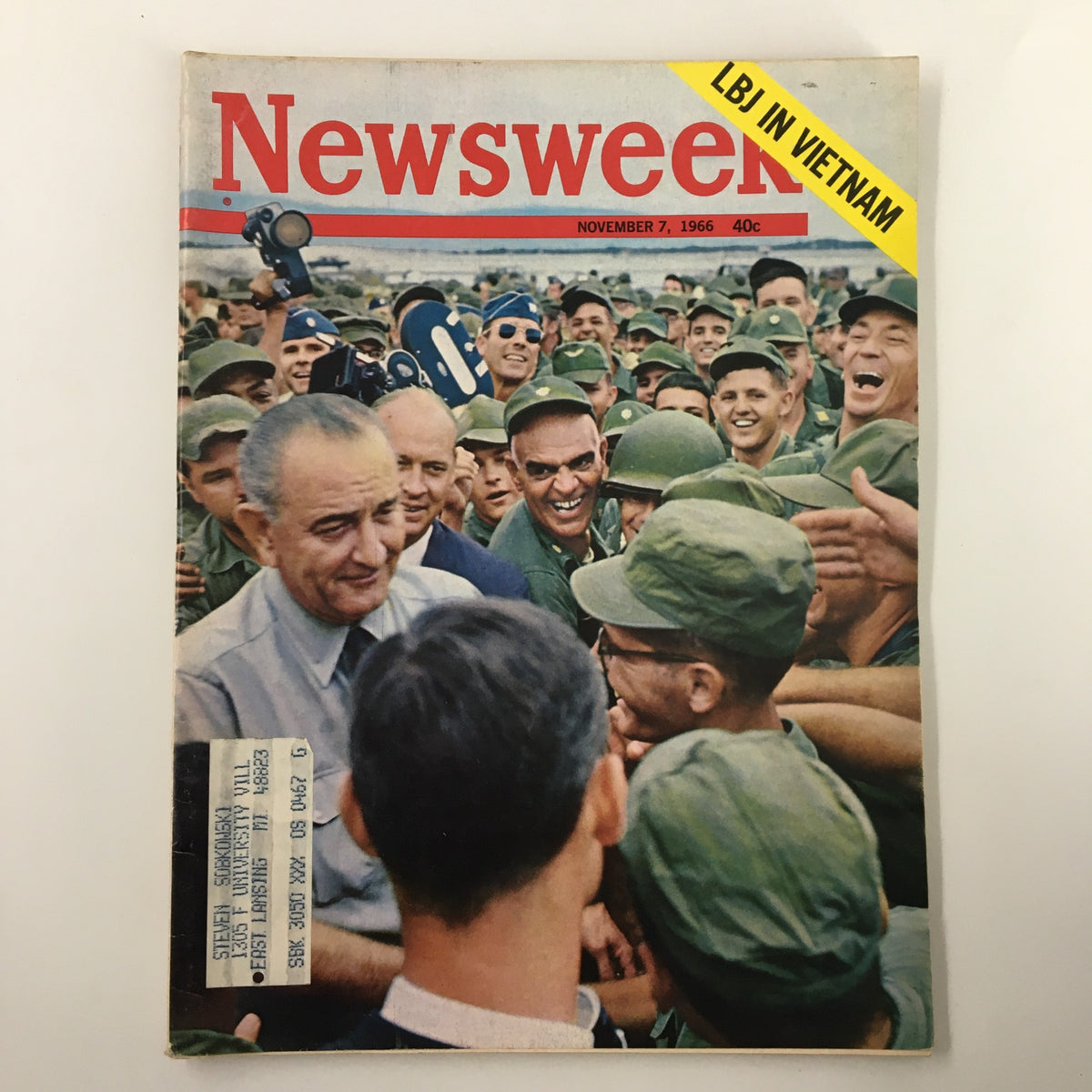Cover of VTG Newsweek Magazine November 7, 1966, featuring a crowd of soldiers and Lyndon B. Johnson during his visit to Vietnam, showcasing the historical context of the Vietnam War.