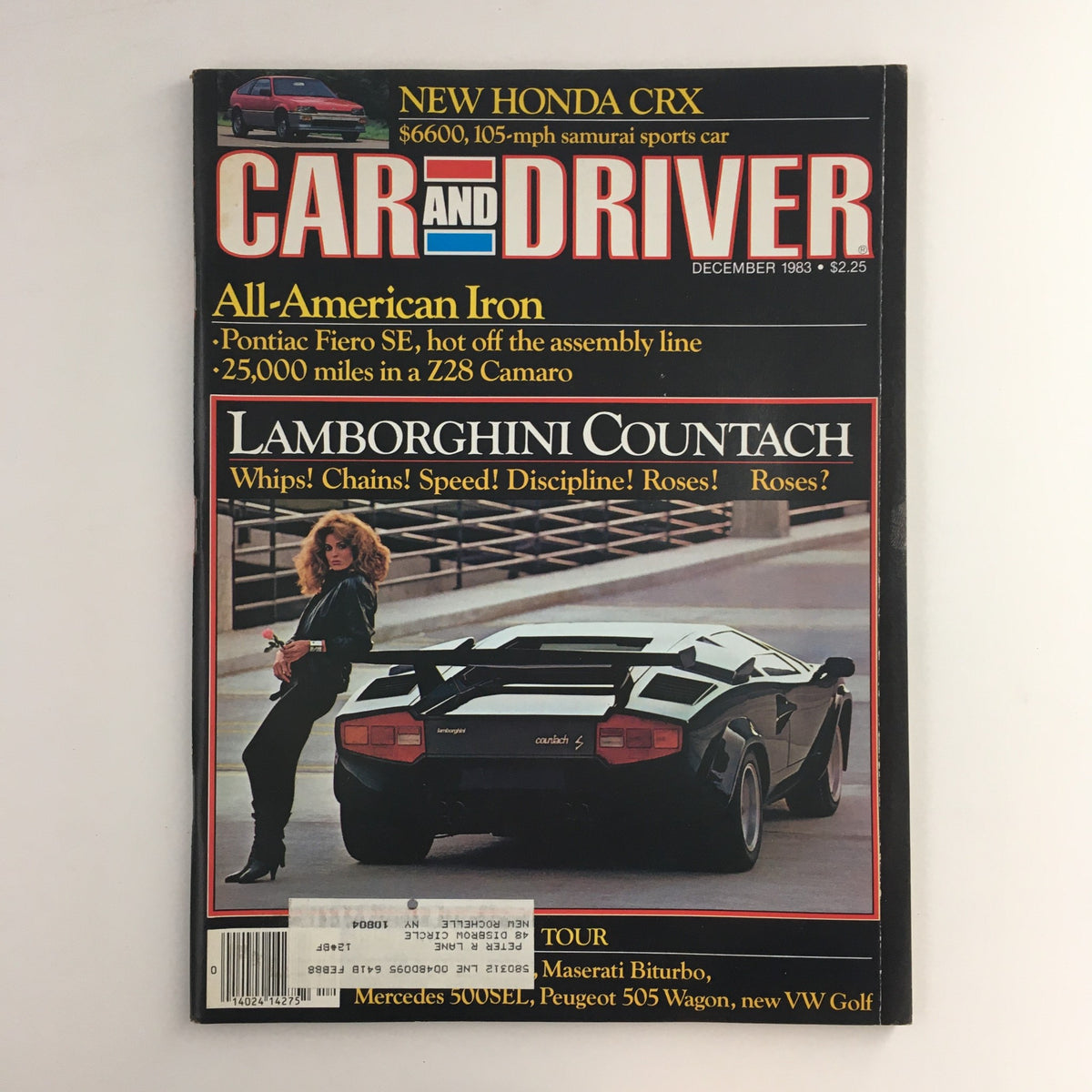 Cover of Car and Driver Magazine December 1983 featuring the Lamborghini Countach and Pontiac Fiero SE, showcasing automotive history with vibrant graphics and nostalgic design.