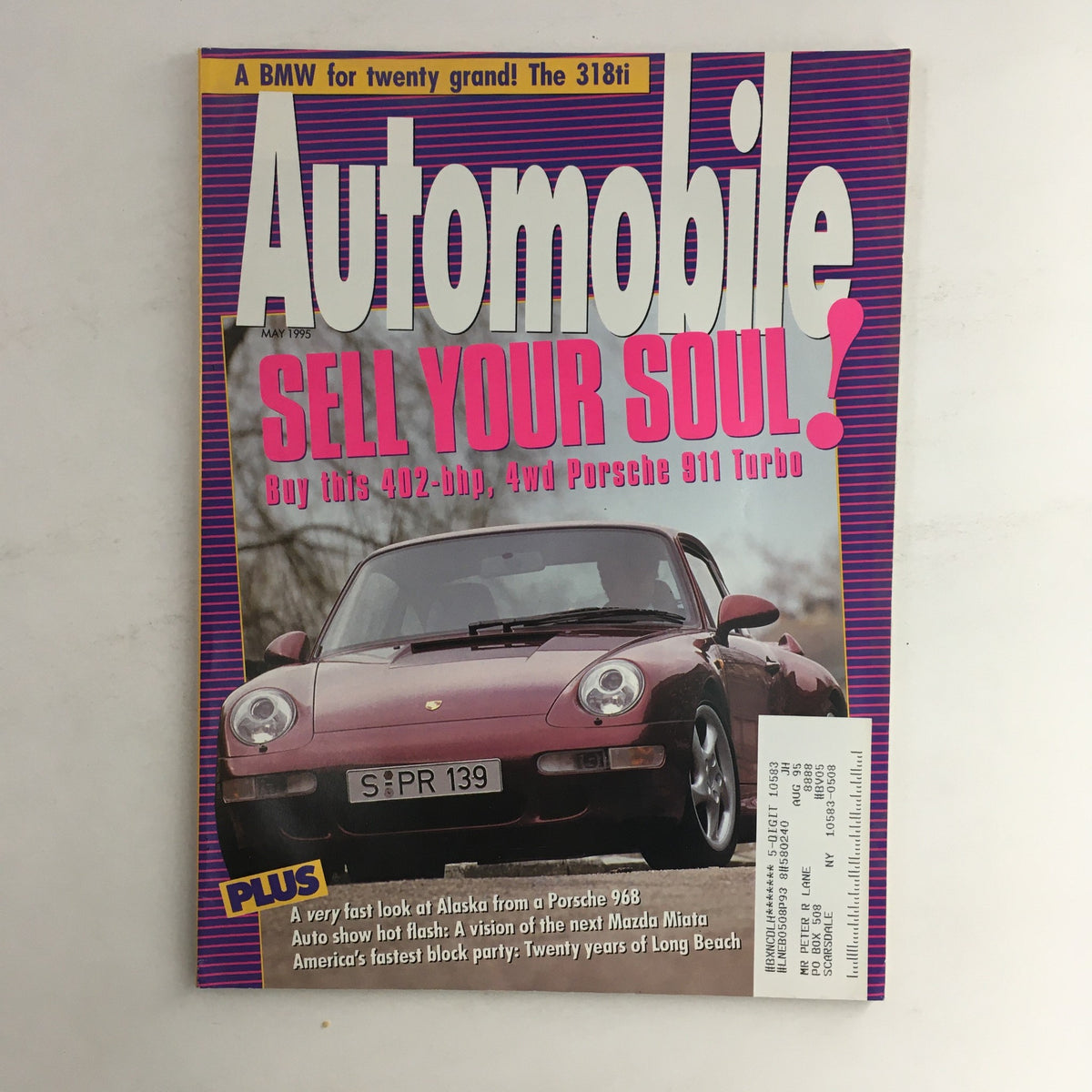 Cover of Automobile Magazine May 1995 featuring the title 'SELL YOUR SOUL!' with a focus on the 402-bhp 4WD Porsche 911 Turbo and the BMW 318Ti, showcasing a vibrant design and automotive themes.