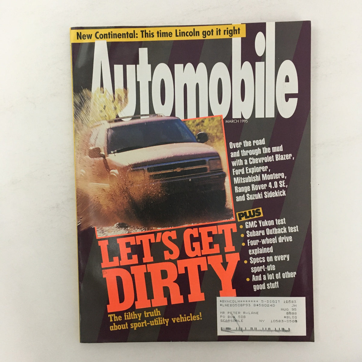 Cover of Automobile Magazine March 1995 featuring the title and a GMC Yukon and Subaru Outback test, with an emphasis on off-road vehicles and SUV performance.