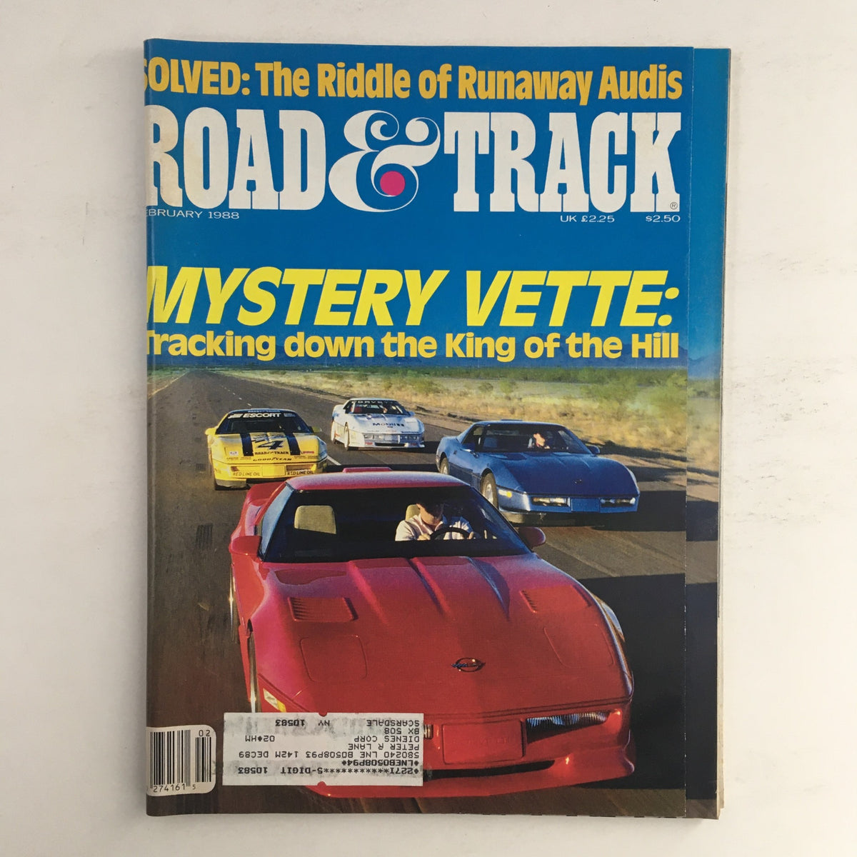 Road & Track Magazine February 1988 issue showcasing the cover story 'Mystery Vette: Tracking down the King of the Hill', featuring a vibrant red Corvette in the foreground with other sports cars on a highway.
