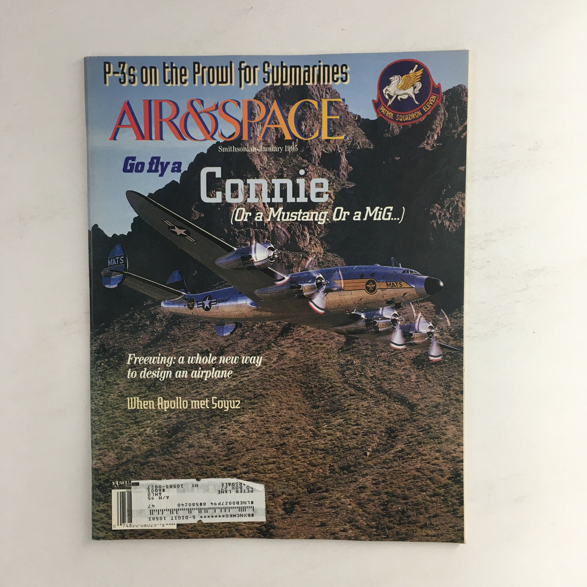 Cover of Air & Space Smithsonian Magazine January 1995 featuring the title 'Go Fly A Connie (Or a Mustang Or a MiG...)', showcasing a Connie aircraft with a scenic mountain backdrop.