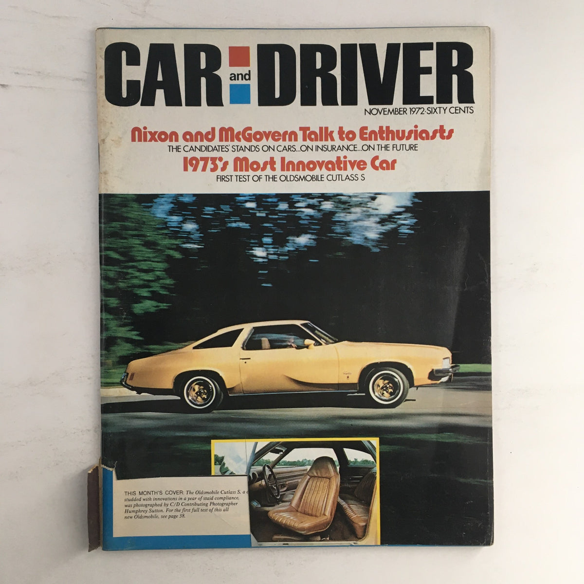 Cover image of the Car and Driver Magazine, November 1972 issue, featuring Nixon and McGovern Talk to Enthusiasts with a yellow Oldsmobile Cutlass S on display, highlighted by iconic automotive journalism from the early 1970s.