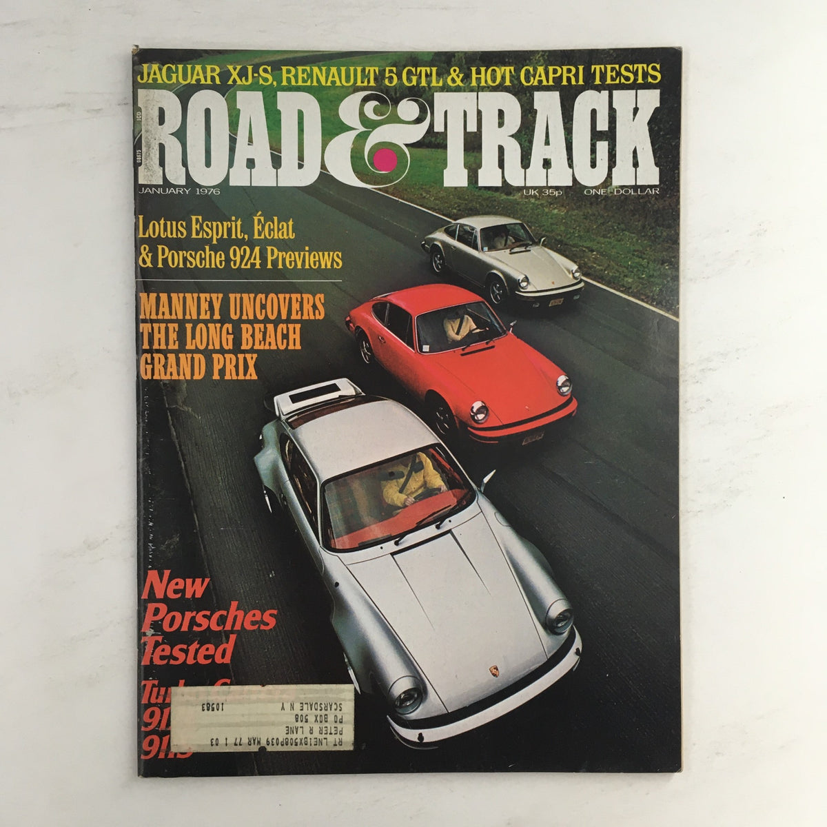 Road & Track Magazine January 1976 cover featuring previews of Lotus Esprit, Eclat, and Porsche 924, showcasing classic cars on the road.