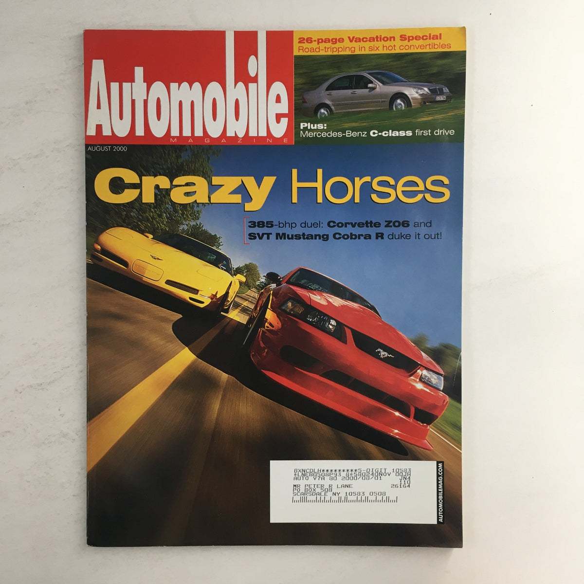 Cover of Automobile Magazine August 2000 featuring a thrilling duel between Corvette Z06 and STV Mustang Cobra R 385-bhp.