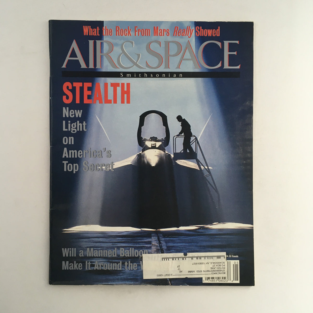 Cover of the Air & Space Smithsonian Magazine from 1996 featuring the title 'Stealth: New Light on America's Top Secret'. The image showcases a stealth aircraft with a silhouette of a technician beside it, highlighting advancements in military aviation technology.