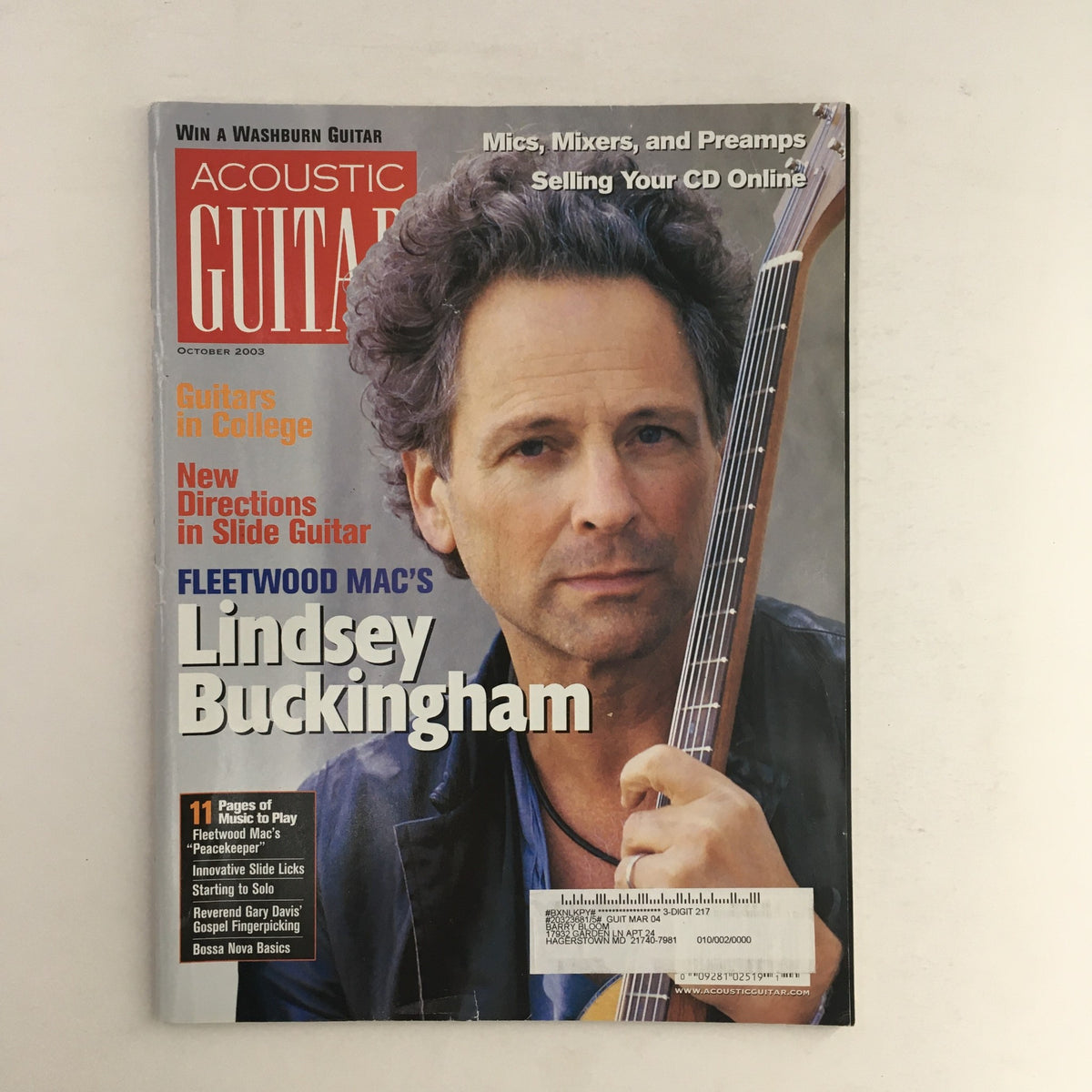 Acoustic Guitar Magazine cover from October 2003 featuring Fleetwood Mac's Lindsey Buckingham, highlighting articles on guitars, music technology, and acoustic guitar techniques.