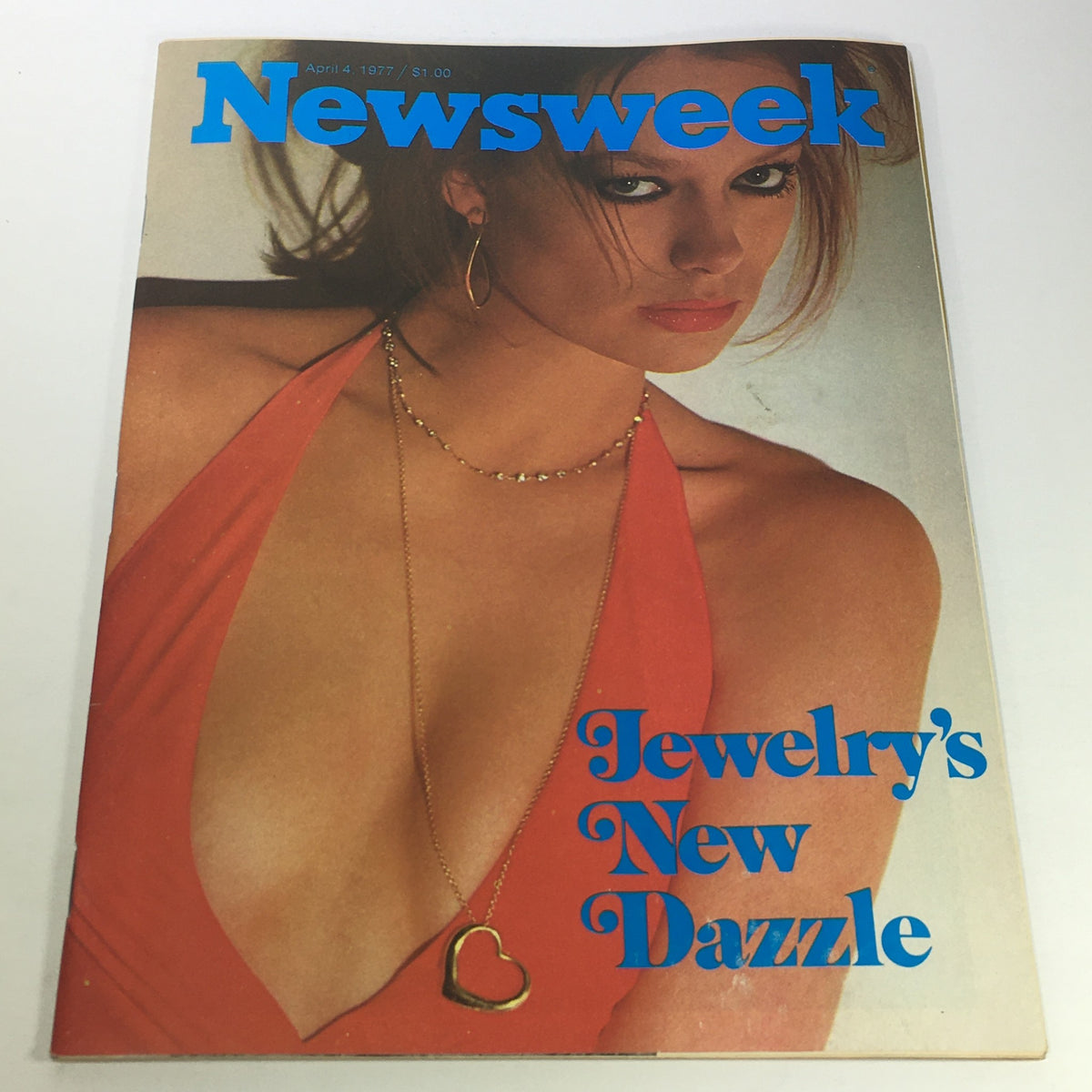 VTG Newsweek Magazine cover from April 4, 1977, featuring the headline 'Jewelry's New Dazzle,' showcasing a model in a striking red outfit with jewelry.