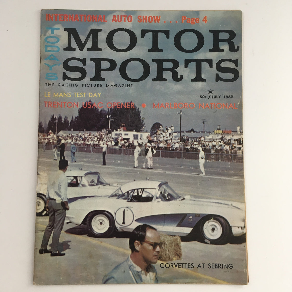 Cover of Today's Motor Sports Magazine, July 1962 issue featuring le Man Test Day, Trenton USAC Opener, and Marlboro National. The image showcases vintage race cars with a crowd in the background, highlighting the excitement of motor sports history.