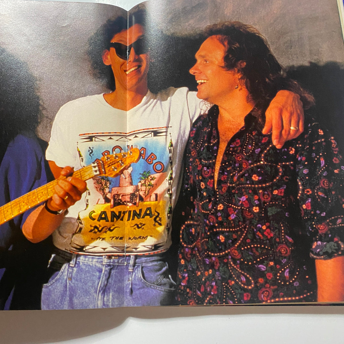 Page from Guitar for the Practicing Musician Magazine August 1991 depicting two musicians enjoying a candid moment, depicting the camaraderie in the rock music scene.