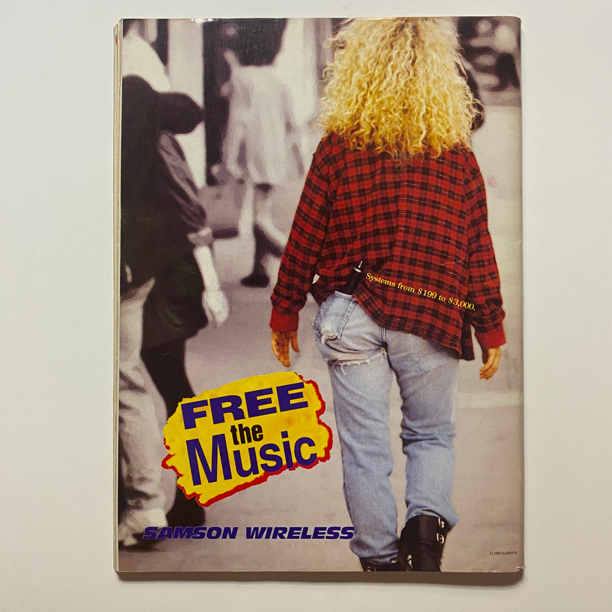 Cover of Samson Wireless promotional material with a woman wearing a plaid shirt, highlighting the slogan 'FREE the Music', related to Guitar for the Practicing Musician Magazine August 1993.