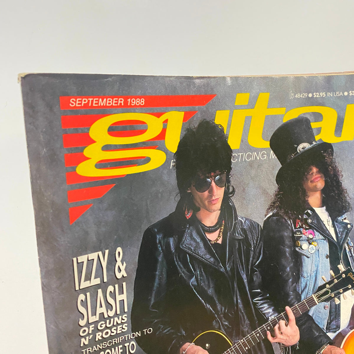 Close-up view of Guitar for the Practicing Musician Magazine September 1988 cover showcasing Izzy and Slash of Guns N' Roses, emphasizing the magazine title and artistic details.