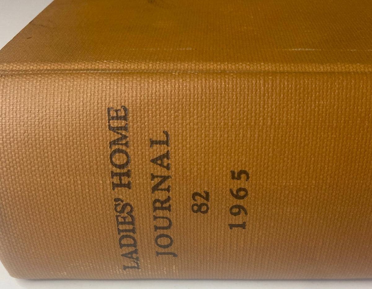 Close-up of the spine of the 1965 Ladies' Home Journal Bound Magazine featuring the title and publication year, showcasing its collectible design.