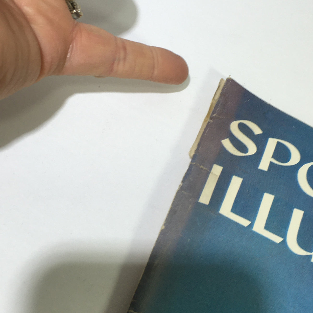 Close-up image of the edge of the Sports Illustrated magazine from August 4, 1958, highlighting the vintage condition and wear typical for its age.