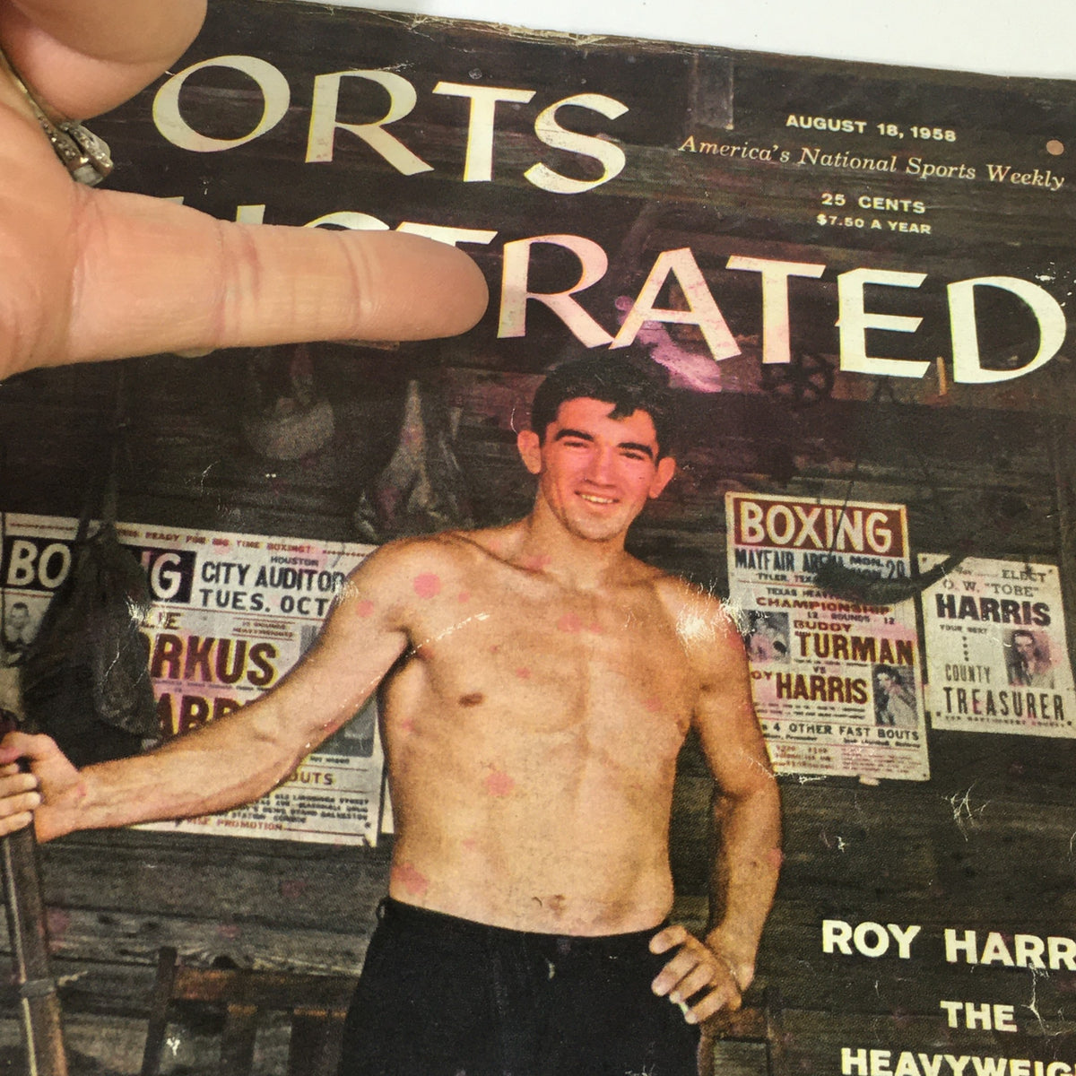 Close-up of the Sports Illustrated Magazine cover August 18, 1958, highlighting heavyweight challenger Roy Harris with boxing advertisements in the background.