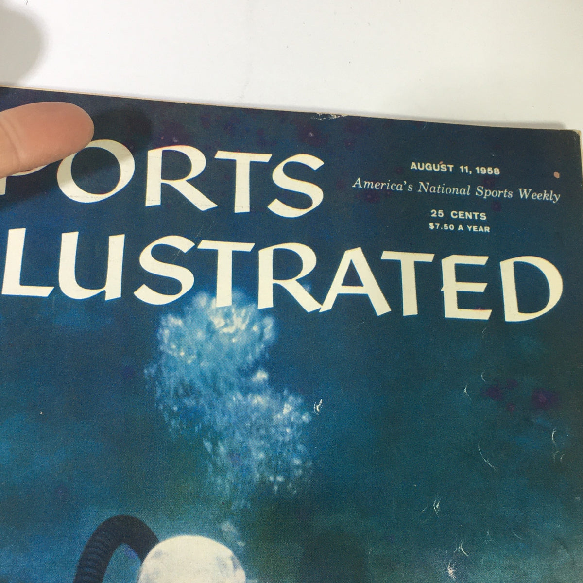 Close-up of the cover of the Sports Illustrated Magazine dated August 11, 1958, showcasing the title and date alongside an intriguing underwater theme.