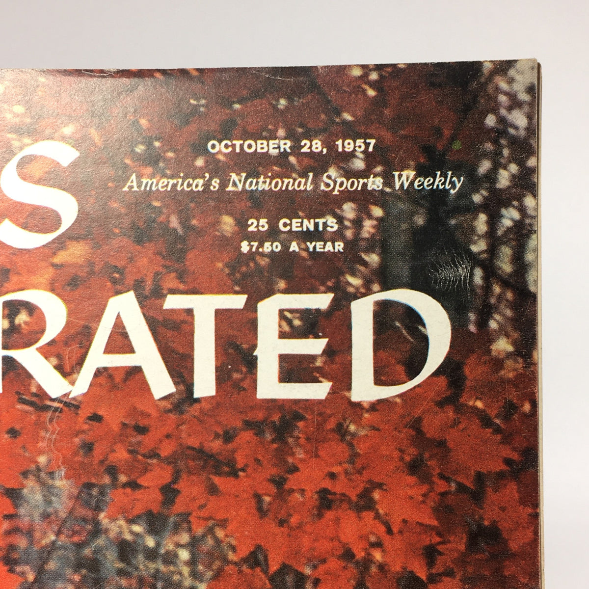 Top corner of the vintage Sports Illustrated Magazine from October 28, 1957, displaying publication details and the title 'A Walk Into Autumn' with autumnal backdrop.