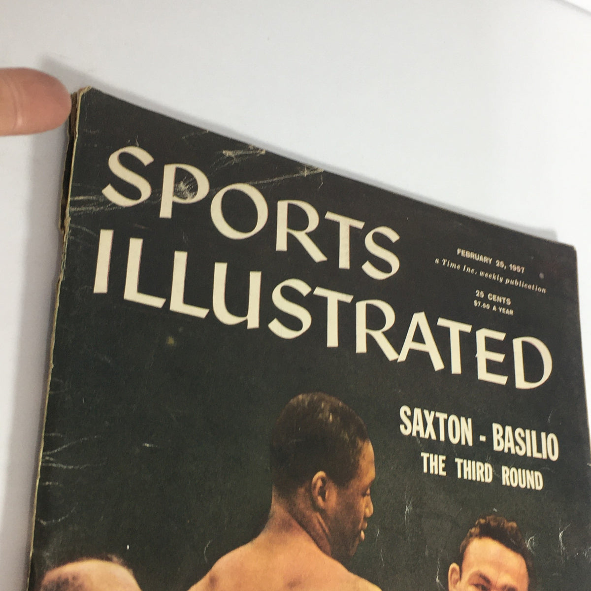 Detailed view of the top corner of the cover of the VTG Sports Illustrated Magazine February 25, 1957, emphasizing the title and date.