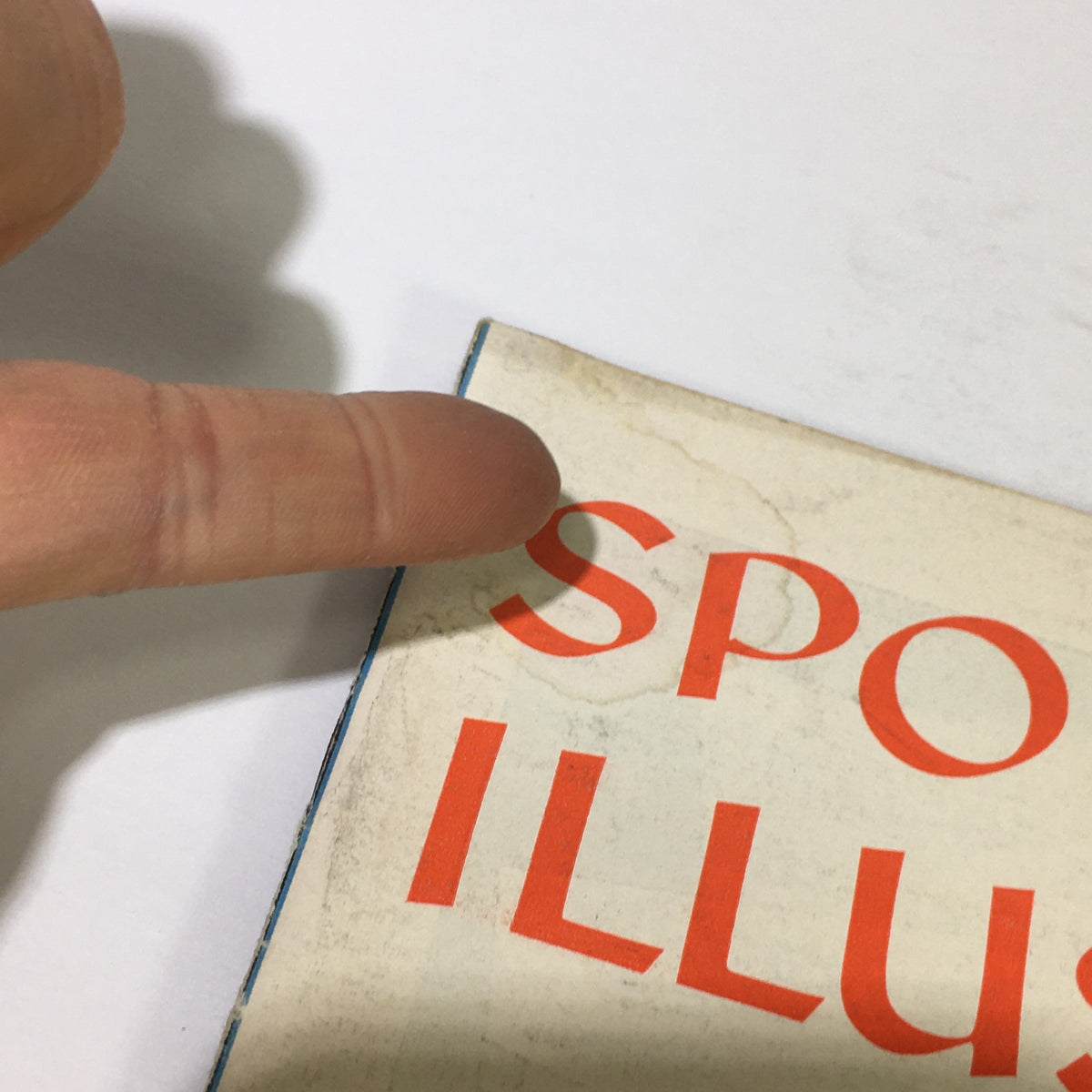 Detail shot of the top corner of the 'VTG Sports Illustrated Magazine May 5 1958', highlighting the magazine's aging and historical significance.