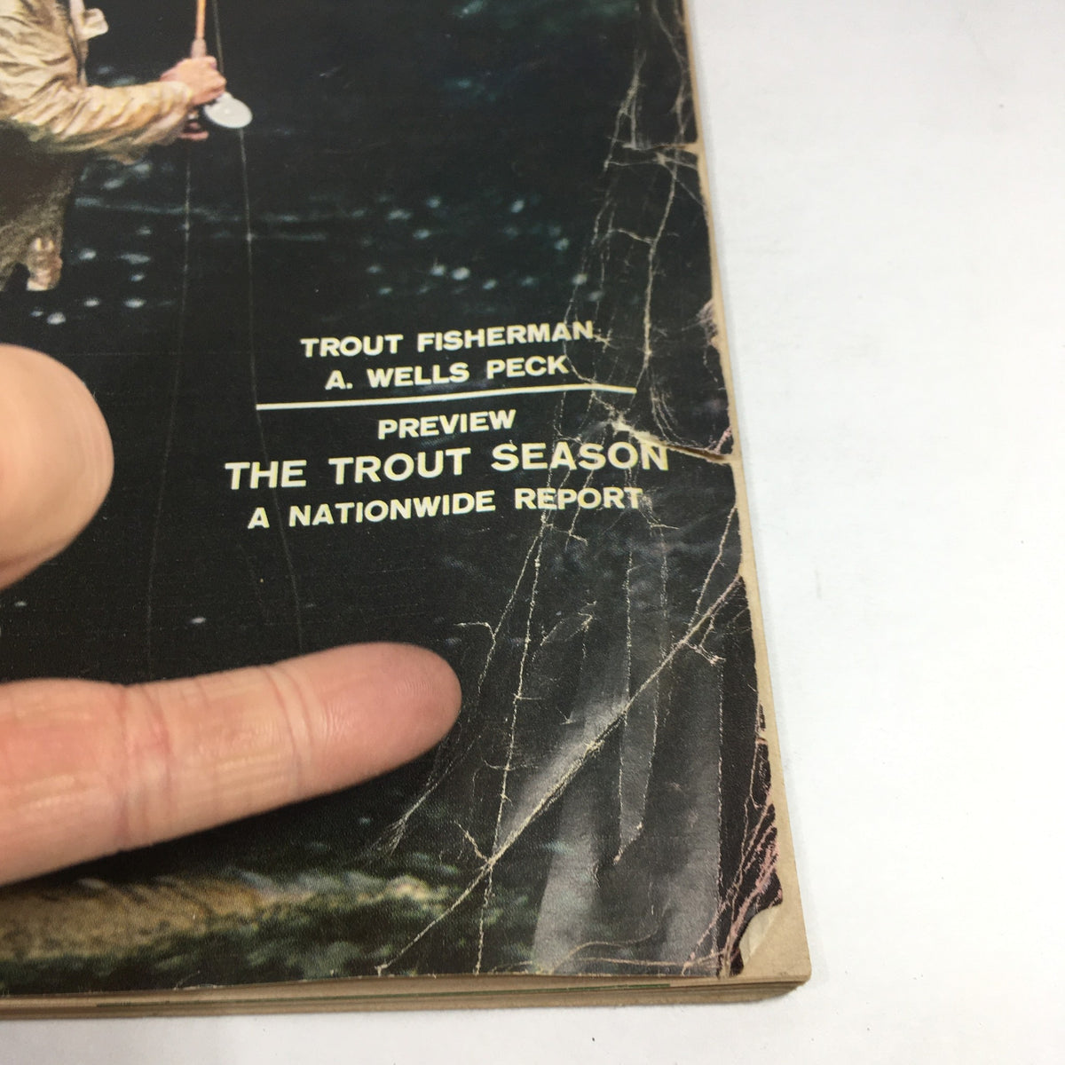 Close-up detail of the April 8, 1957 Sports Illustrated magazine cover displaying the title 'The 5th Lesson by Ben Hogan', with the outline of fishing tackle visible.
