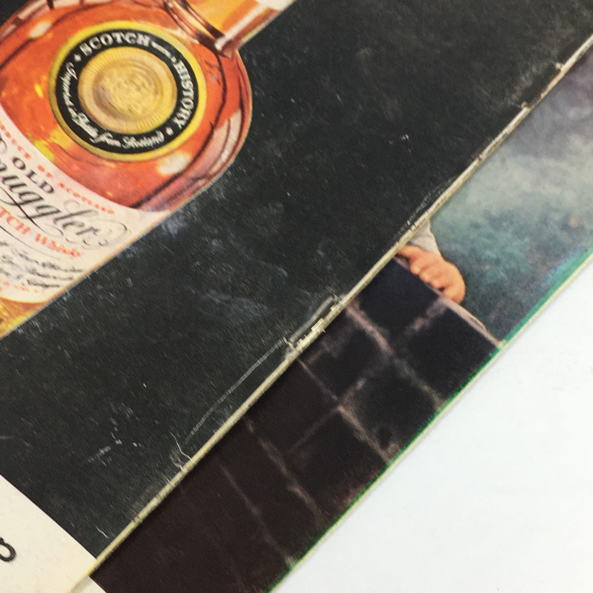 The back cover of the April 8, 1957 Sports Illustrated magazine, displaying an advertisement for Old Smuggler Scotch. The vintage magazine shows signs of age, including wear and scuffing.