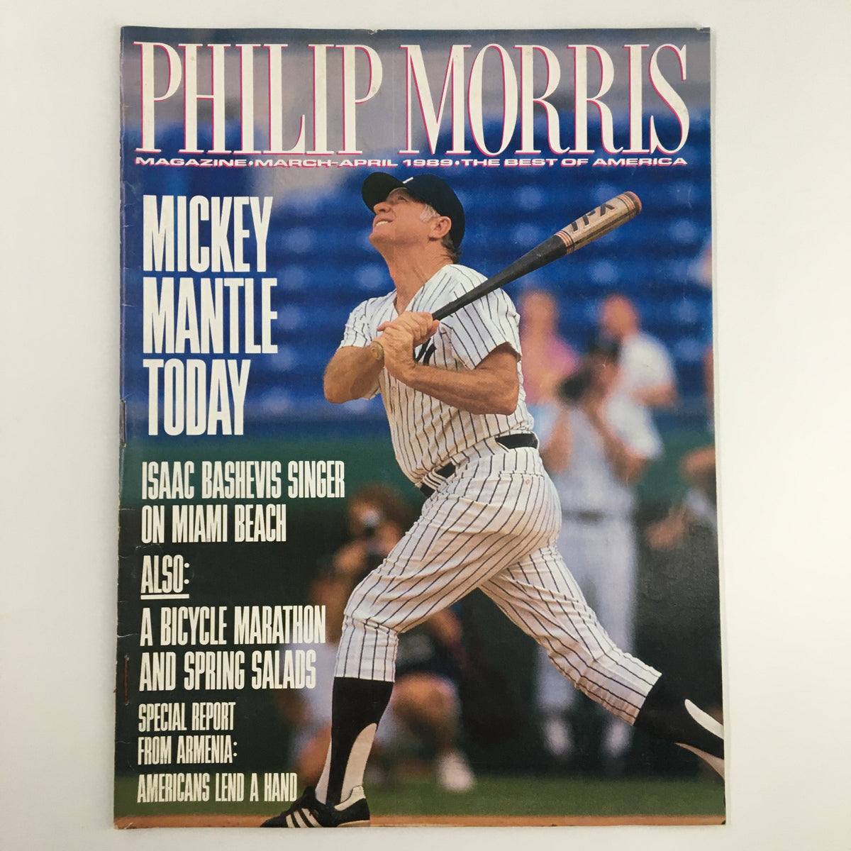 Philip Morris Magazine March 1989 cover featuring a baseball player, Mickey Mantle, swinging a bat. The issue includes articles by Isaac Bashevis Singer and highlights cultural insights from that era.