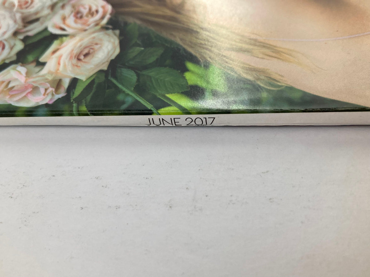 Close-up of the spine of Vogue Magazine June 2017, indicating the publication date and showcasing the magazine's vintage charm.