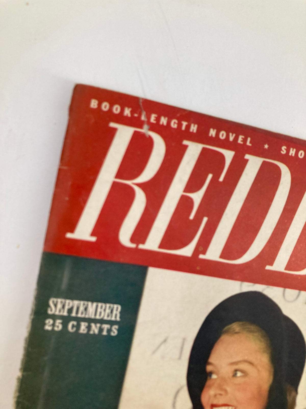 Close-up of VTG Redbook Magazine September 1947 cover highlighting the title and price, featuring a woman in a red coat.