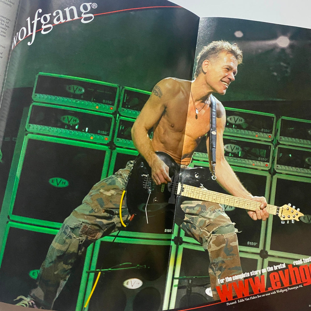 Inside spread of Guitar World Magazine February 2009 depicting Eddie Van Halen performing shirtless in front of amplifiers, capturing the essence of rock music.