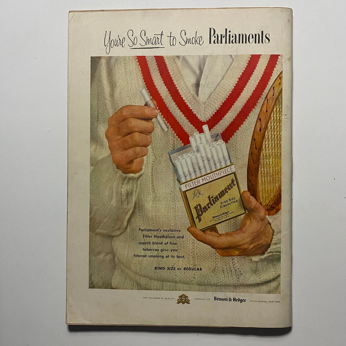 Vintage advertisement featuring a person holding a pack of Parliament cigarettes, promoting the slogan 'You’re So Smart to Smoke Parliaments'. This retro ad showcases a stylish presentation, perfect for collectors of historical tobacco marketing. Featured alongside the Sports Illustrated Magazine August 16 1954.
