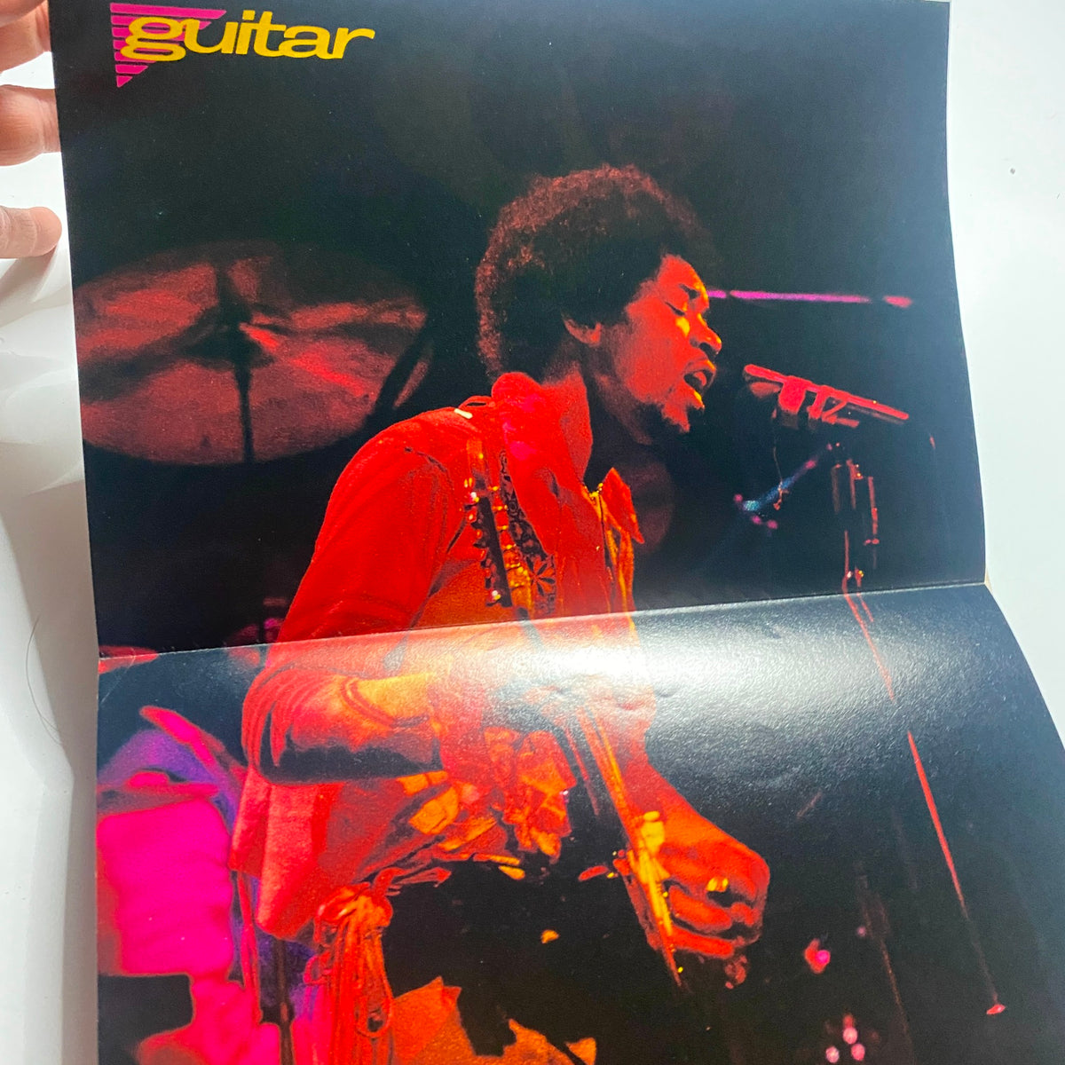 Inside spread of the Guitar for the Practicing Musician Magazine October 1989 featuring a vibrant poster of Jimi Hendrix performing with a guitar, highlighting iconic moments in rock history.