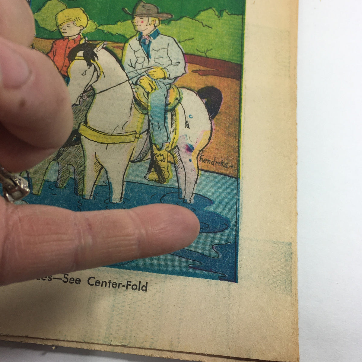 Close-up view of the vintage VTG TV Week's Complete TV Listings May 16-23 1970 magazine cover, focusing on the illustration of two cowboys on horseback by the water, with emphasis on the charming retro art style.
