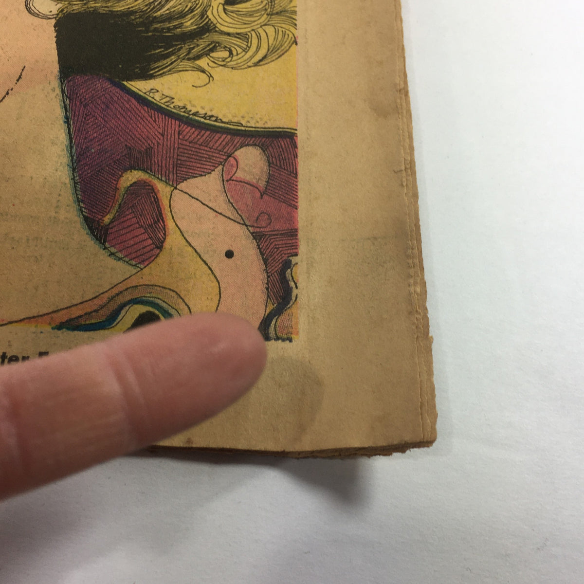 Close-up view of VTG TV Week's Complete TV Listings July 18-25 1970, highlighting the colorful illustration on the cover with a finger pointing to the edge.