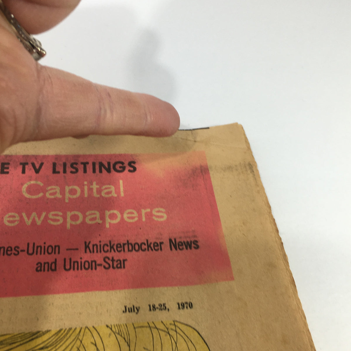 Close-up of the cover of VTG TV Week's Complete TV Listings July 18-25 1970, showcasing the title and publication details with a finger pointing at the corner.