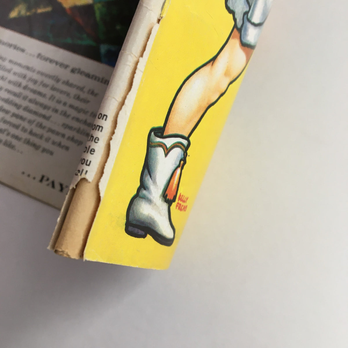 Close-up of the spine of Mad Magazine December 1959 No. 51 showing light wear with distinct artwork of a character's leg and boot.