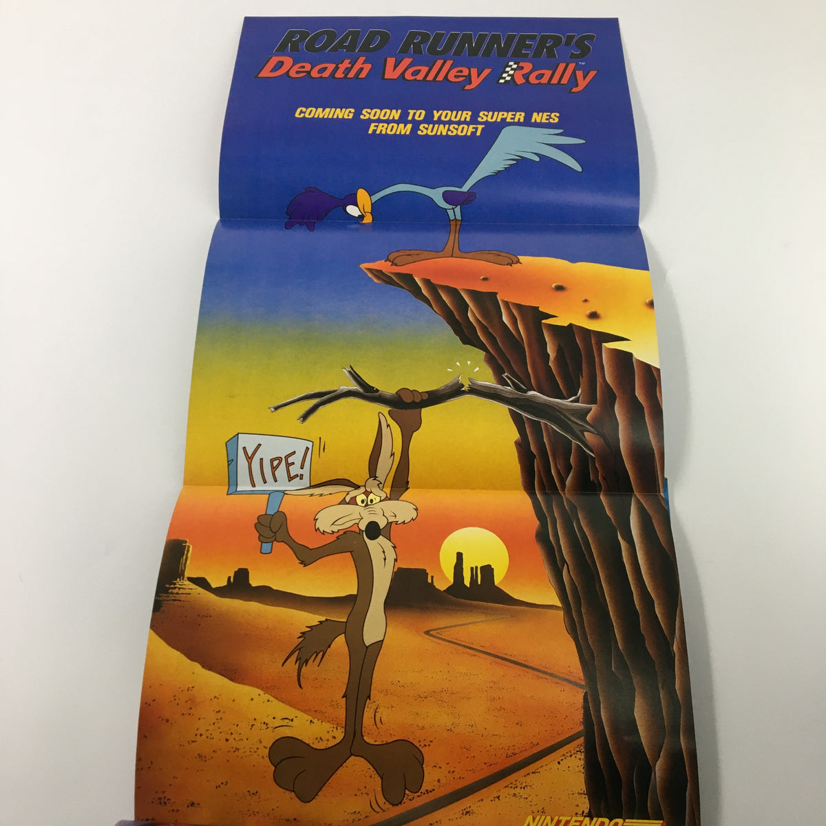 Vibrant artwork of Road Runner's Death Valley Rally showcasing Wile E. Coyote holding a sign that says 'Yipe!' against a desert backdrop. Featured in Nintendo Power Magazine, Issue #41 from October 1992.