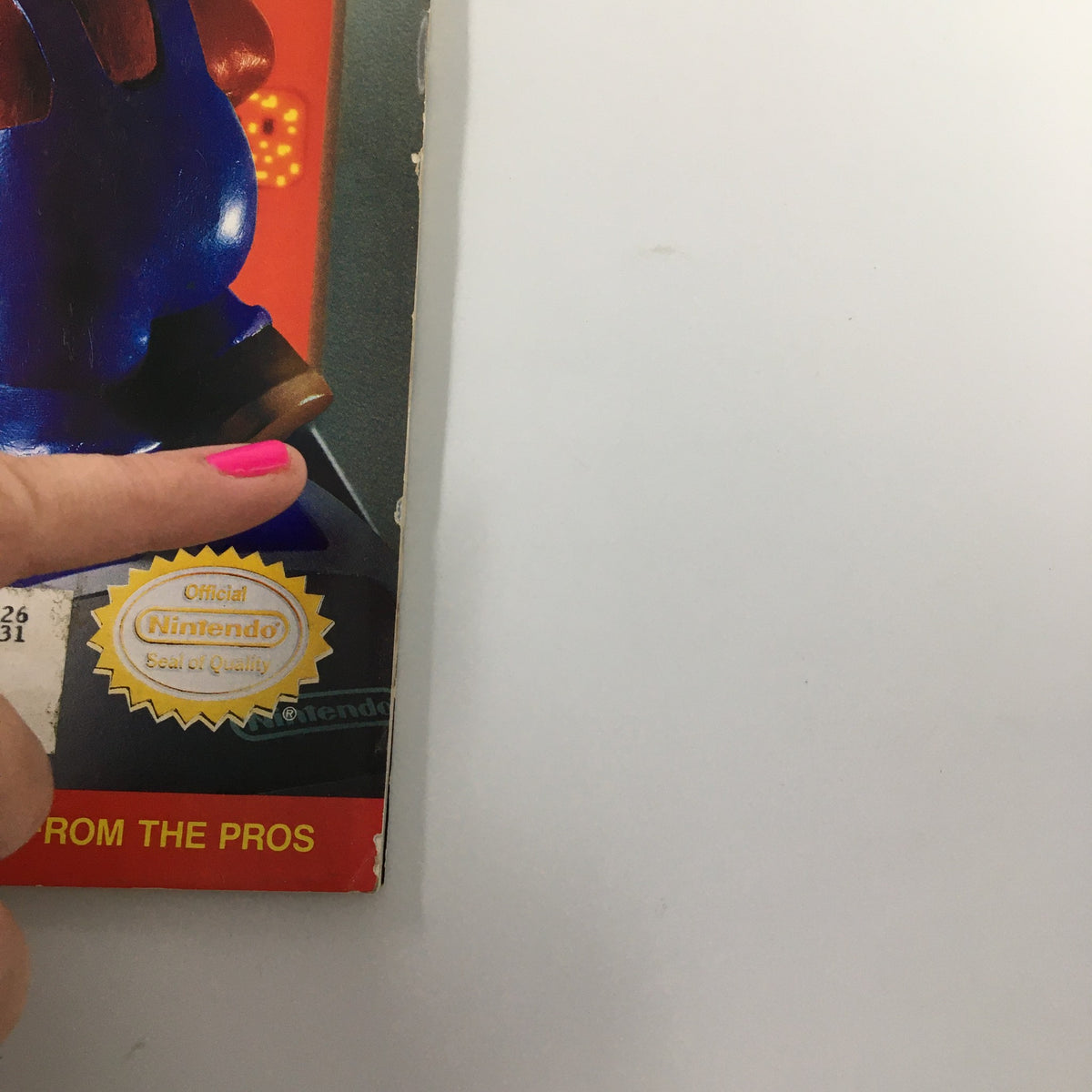 Detailed view of the back corner of Nintendo Power Magazine August 1992, Issue #39, displaying the official Nintendo Seal of Quality and slight wear.