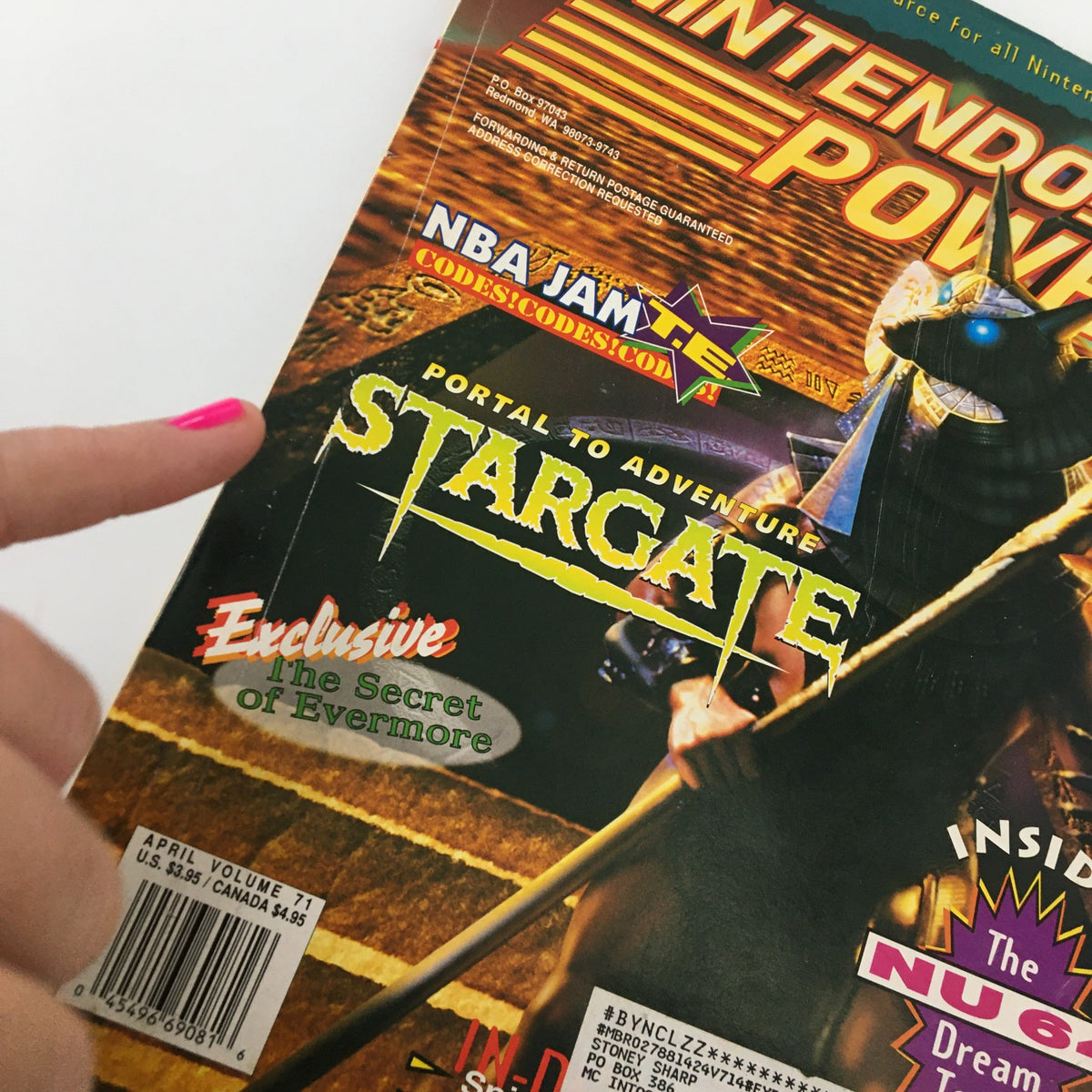 Close-up of Nintendo Power Magazine April 1995 #71 cover, showcasing the title 'Portal to Adventure: Stargate' and emphasizing exclusive content including tips for The Secret of Evermore.