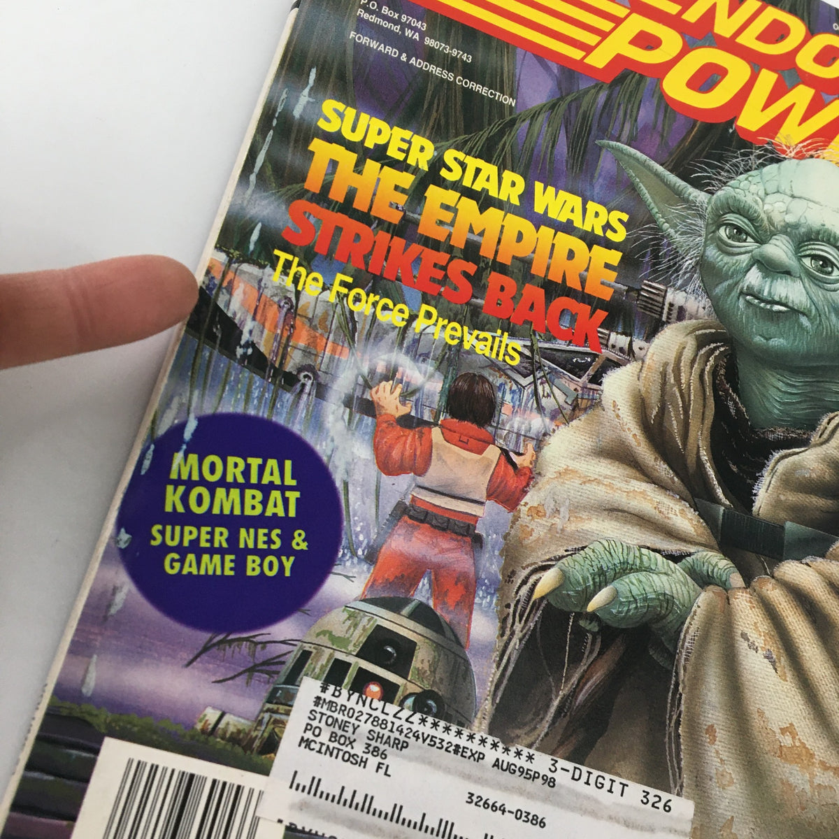 Detail of the cover of Nintendo Power Magazine October 1993 #53 showing Yoda and Mortal Kombat promotion. This vintage magazine highlights Star Wars: The Empire Strikes Back and includes historical gaming references.