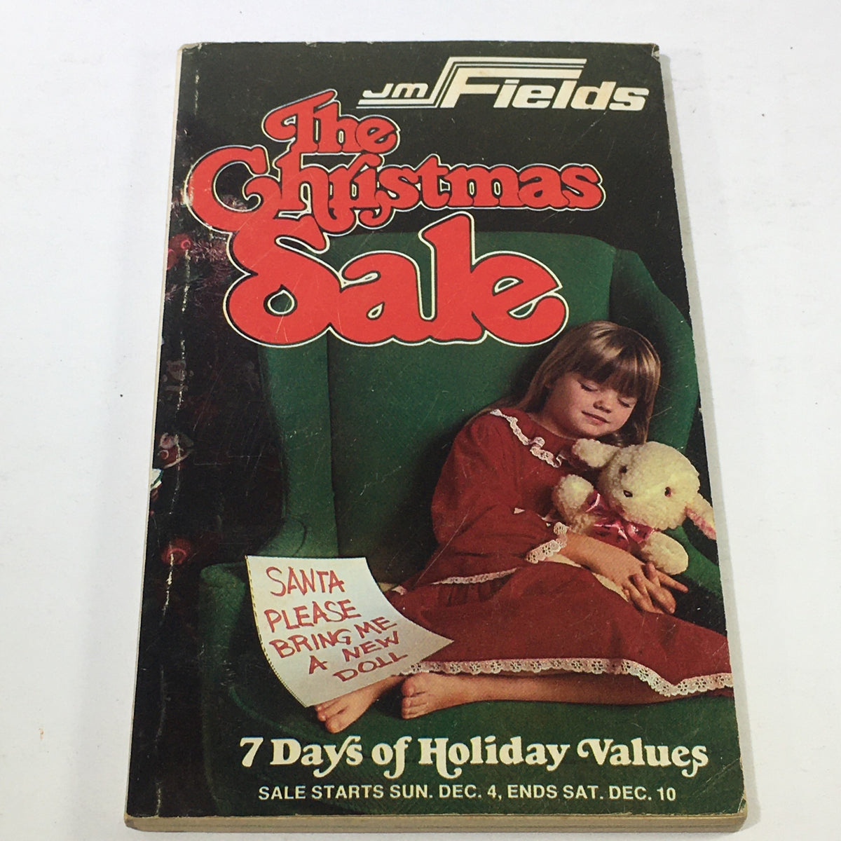 Cover of the VTG JM Fields The Christmas Sale Price Guide Catalog 1970s featuring a young girl in a holiday dress with a plush toy.