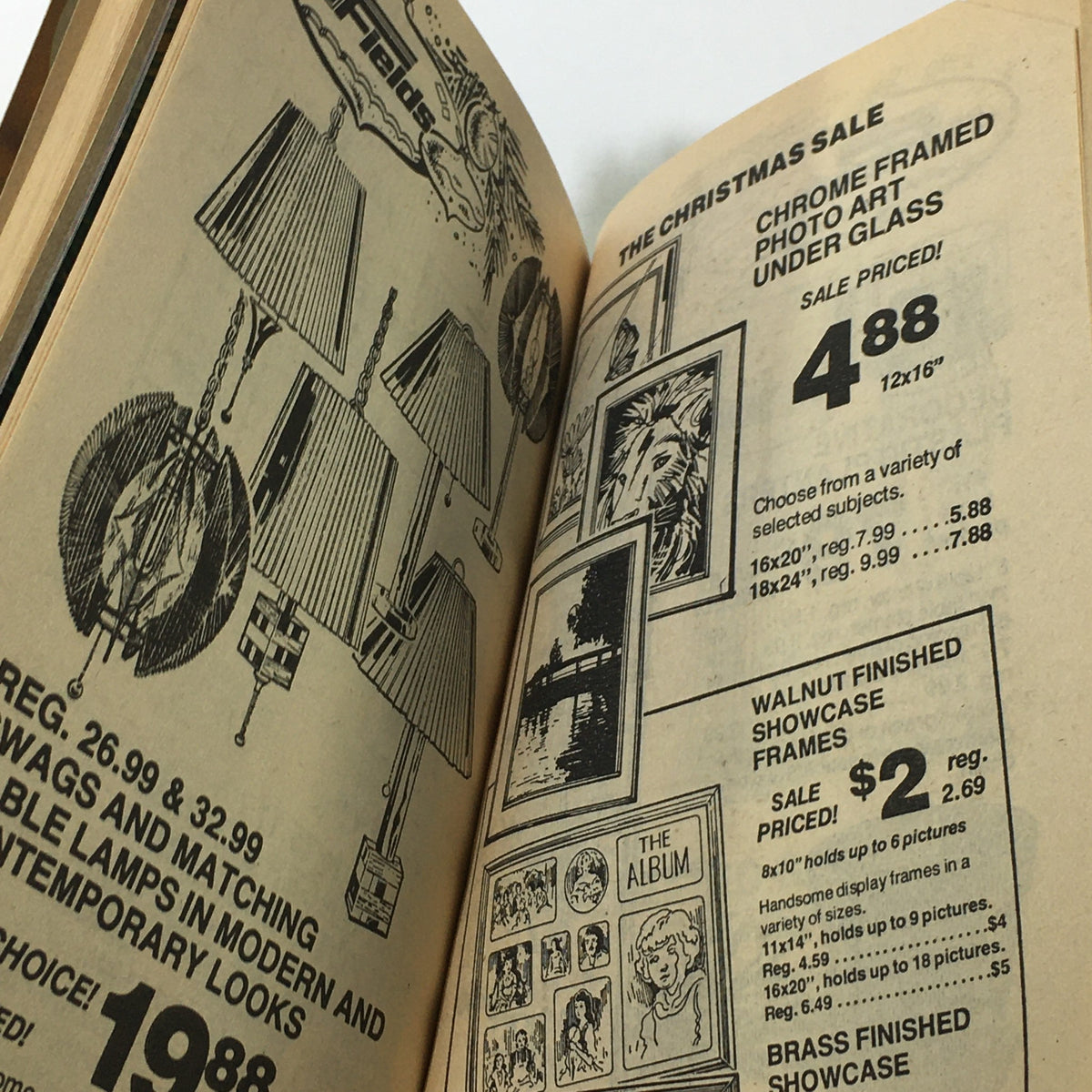 Inside page of the Vintage JM Fields The Christmas Sale Price Guide Catalog featuring chrome framed photo art under glass and lamps with sale prices from the 1970s.