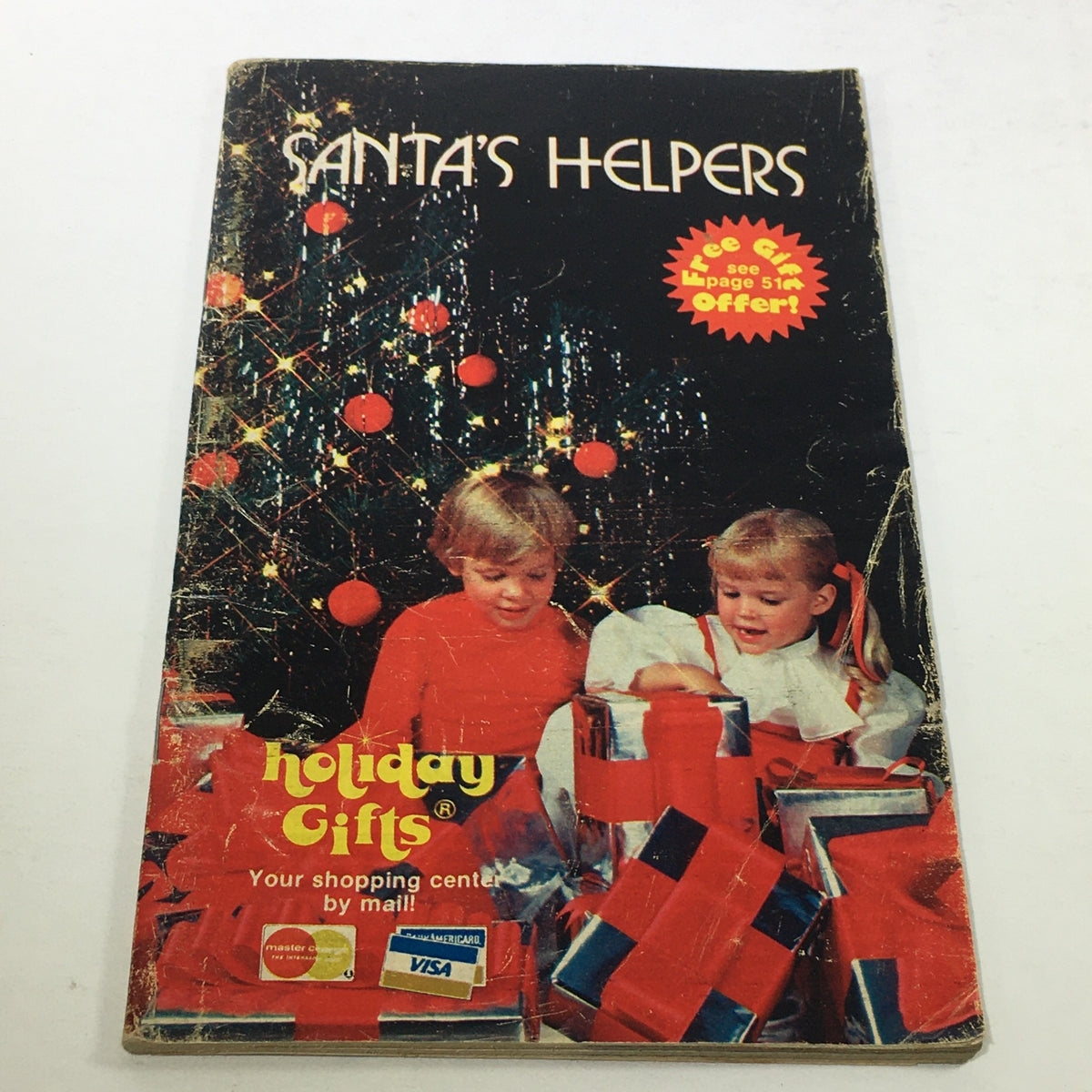 Cover of the VTG Rare Santa's Helpers Holiday Gifts Price Guide Catalog 1967 featuring children with presents and festive decorations.