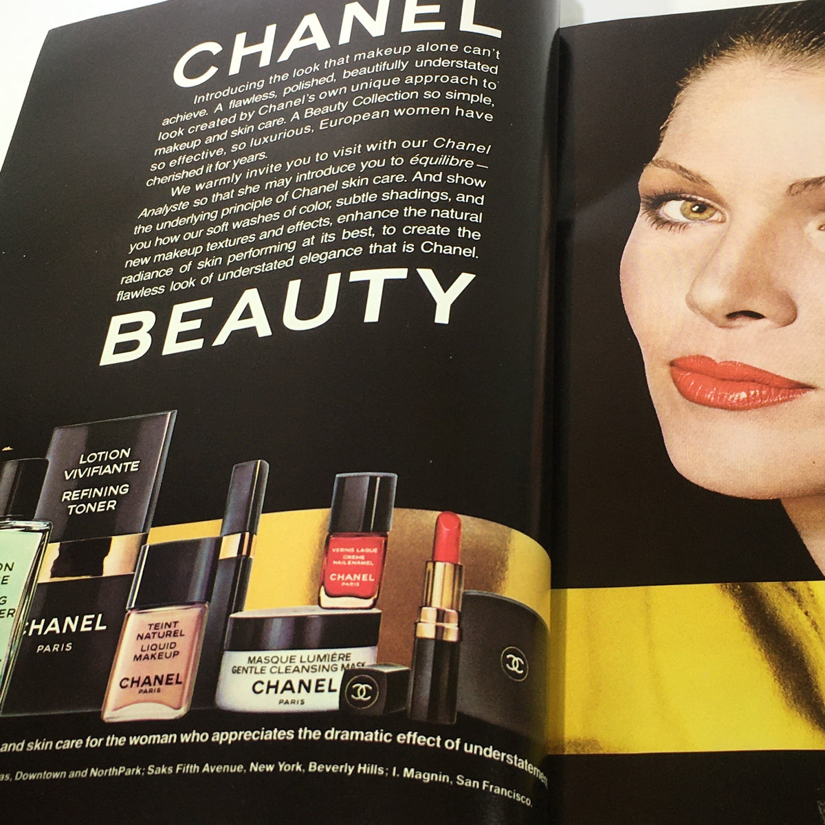 Inside page of VTG L'Officiel USA Magazine Fall Collection Issue 1976 showcasing a Chanel Beauty advertisement with various makeup products and a model with elegant makeup.