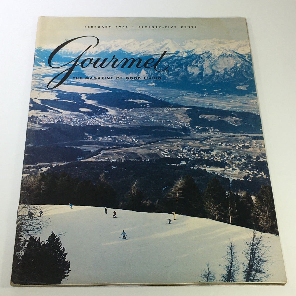 VTG Gourmet The Magazine of Good Living February 1975 cover featuring a picturesque snow-covered landscape and skiing scene, capturing the essence of gourmet living in the 1970s.