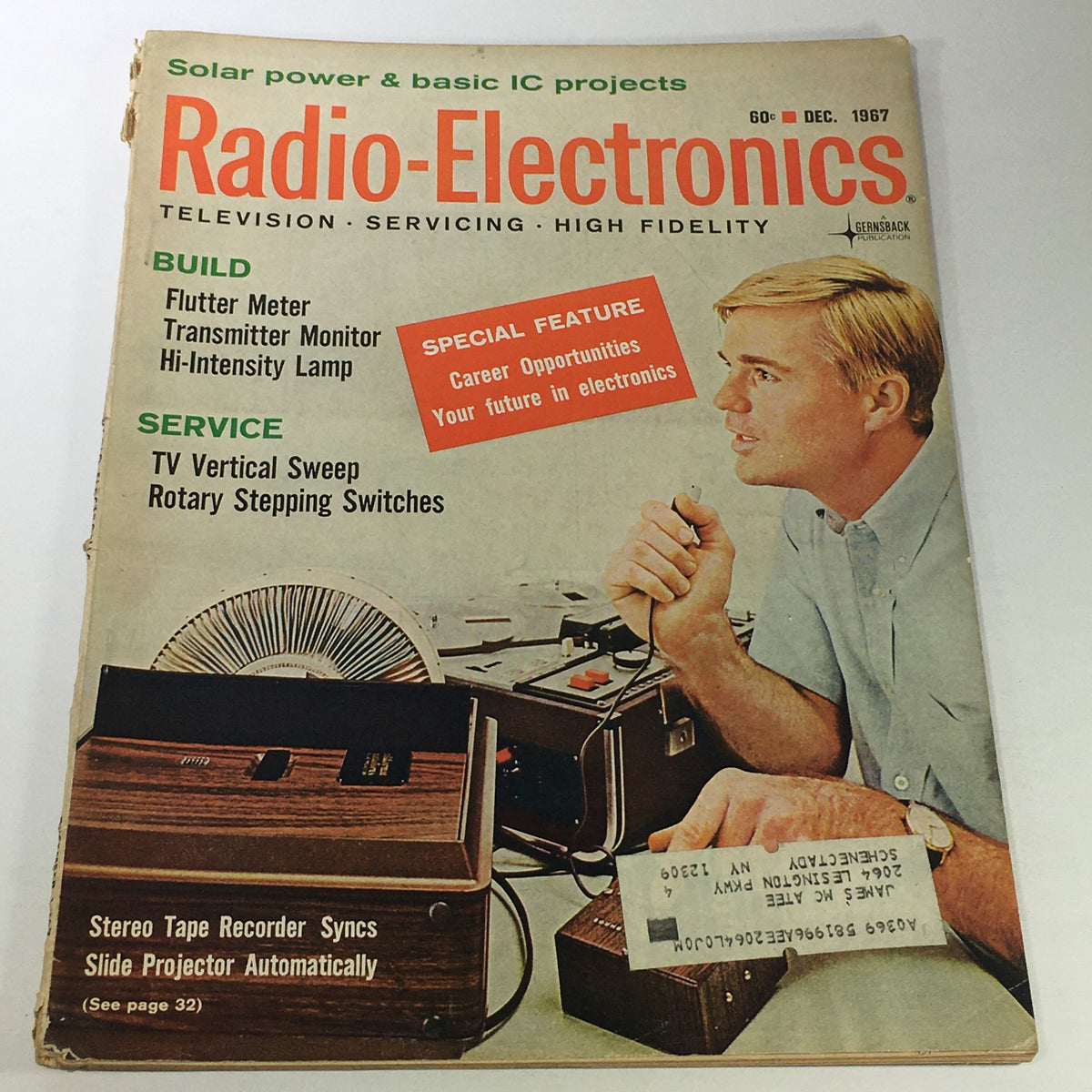 Cover of the VTG Radio-Electronics Magazine December 1967 featuring articles on TV vertical sweep and flutter meters, showcasing a man engaged in electronics work with various devices and a fan in the background.