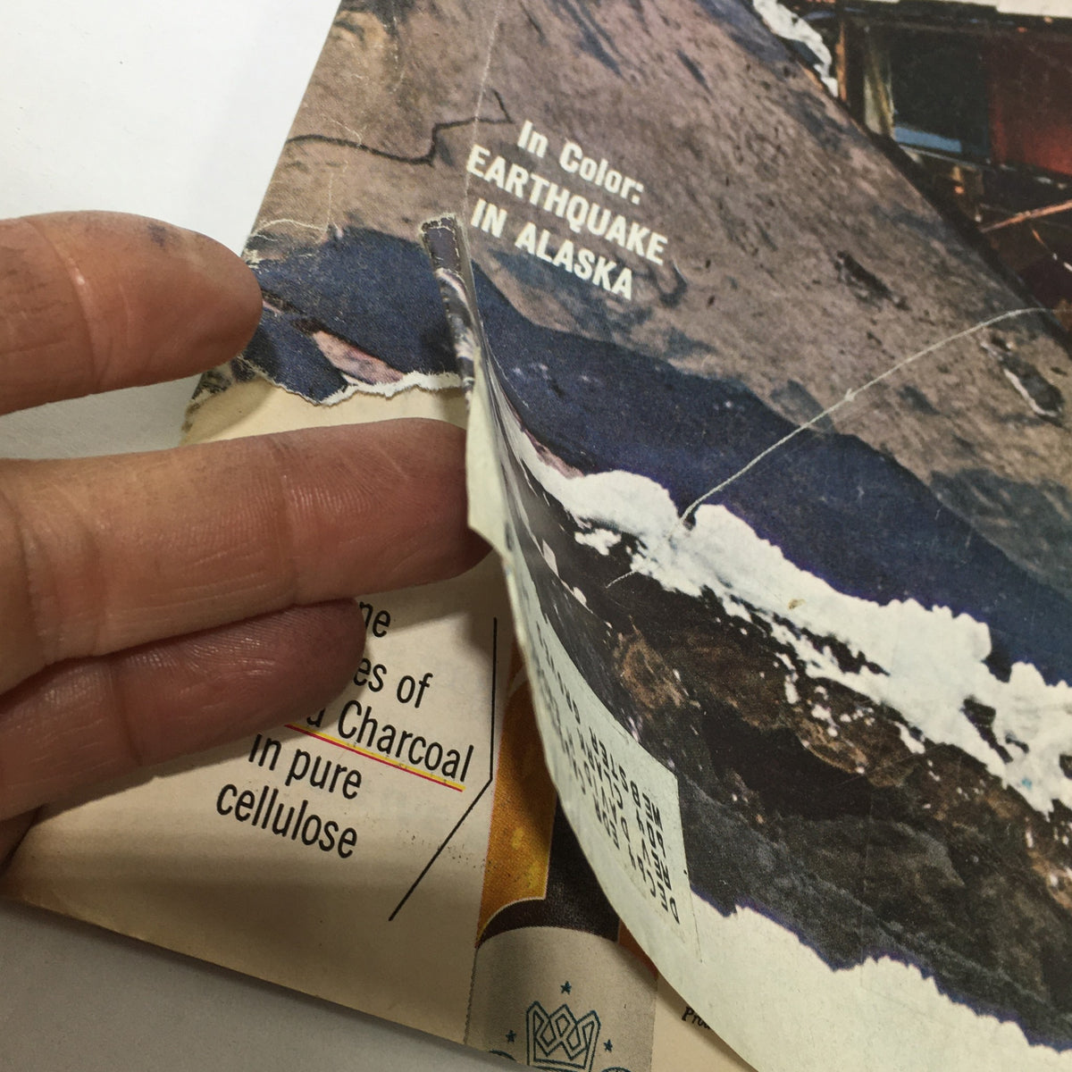Close-up view of the VTG Life Magazine April 10 1964 cover with visible wear, featuring text about the Earthquake in Alaska.